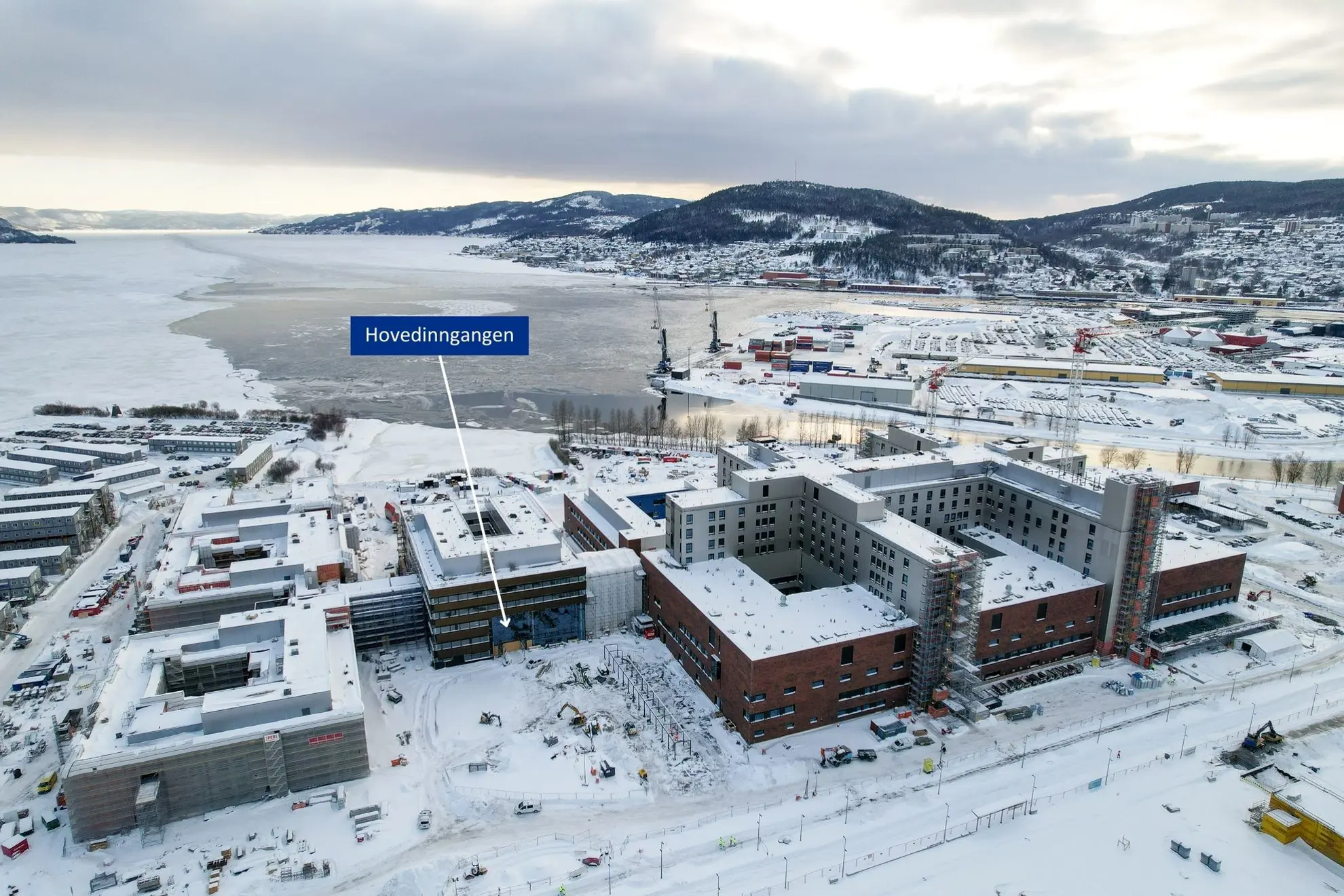 En stor bygning med et skilt midt i et snødekt landskap