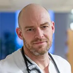 A bald man with a white shirt