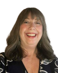 En person med langt hår som smiler