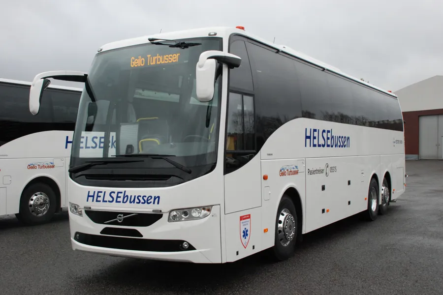 En hvit buss parkert på en parkeringsplass