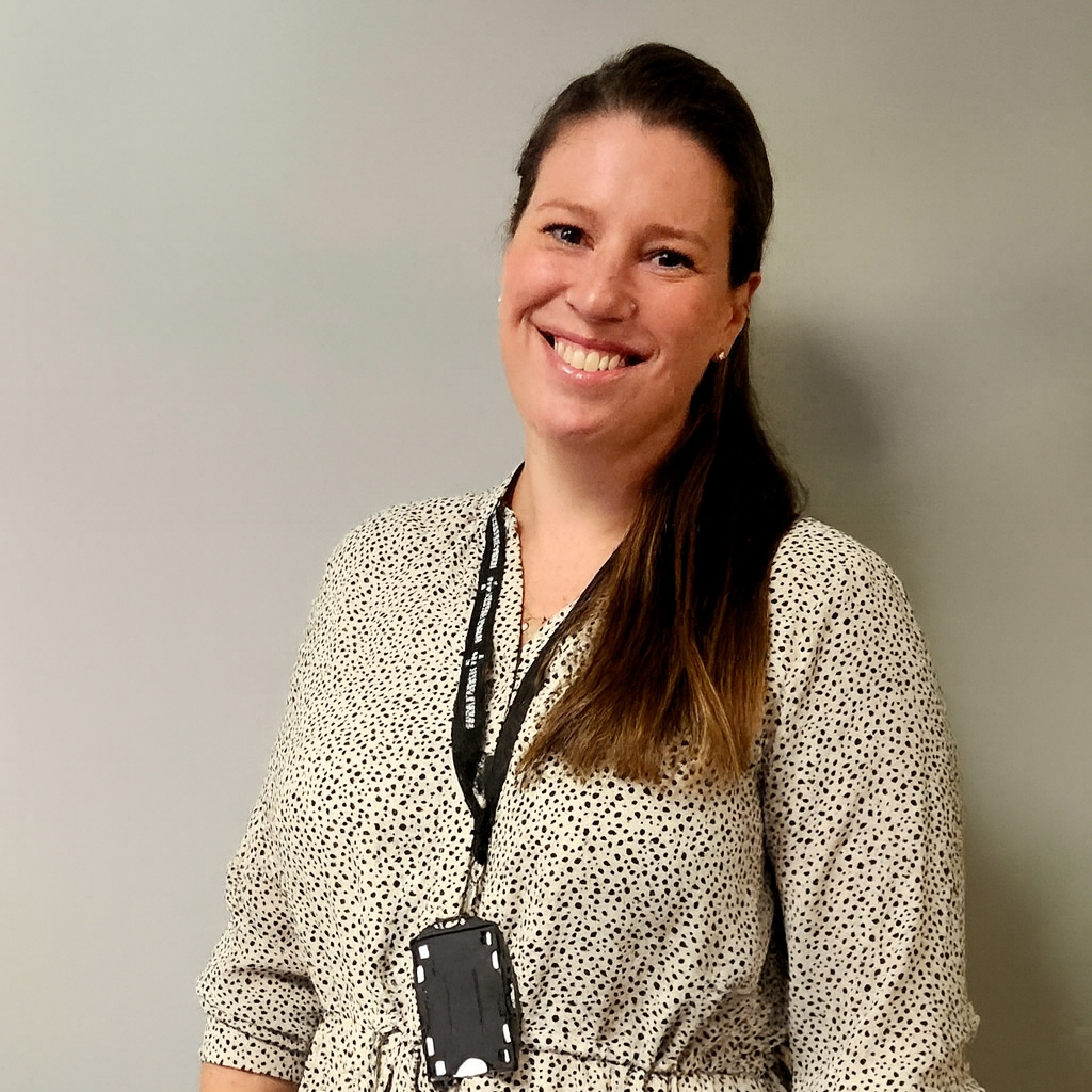 En kvinne som smiler til kameraet