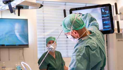 A couple of surgeons performing surgery