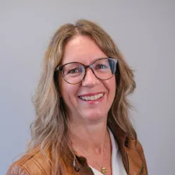 A person with long hair and glasses