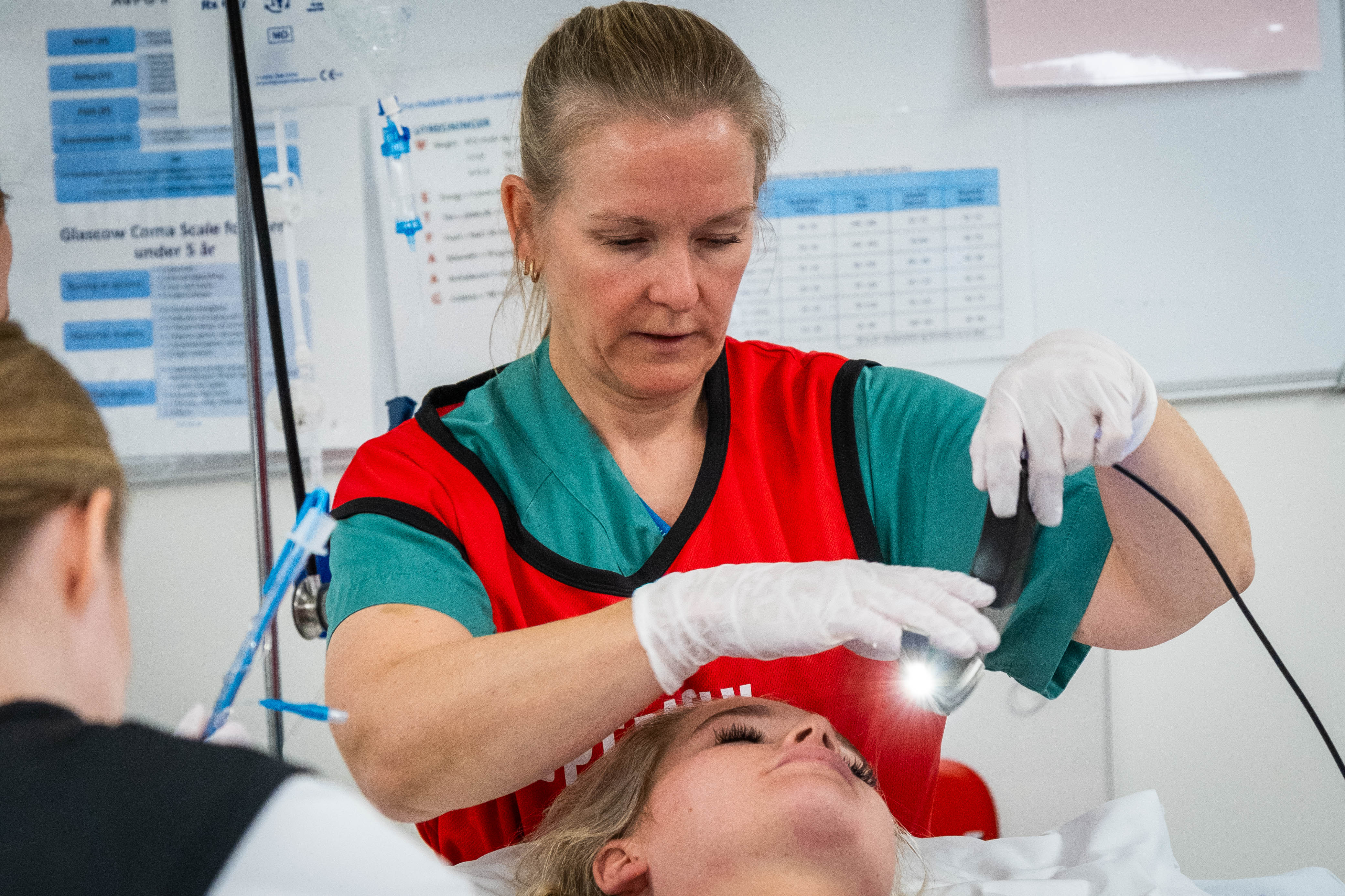 En mann i rød og hvit uniform som holder en baby