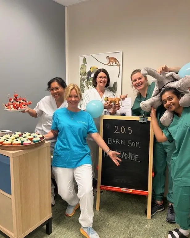 En gruppe mennesker som står rundt et skilt