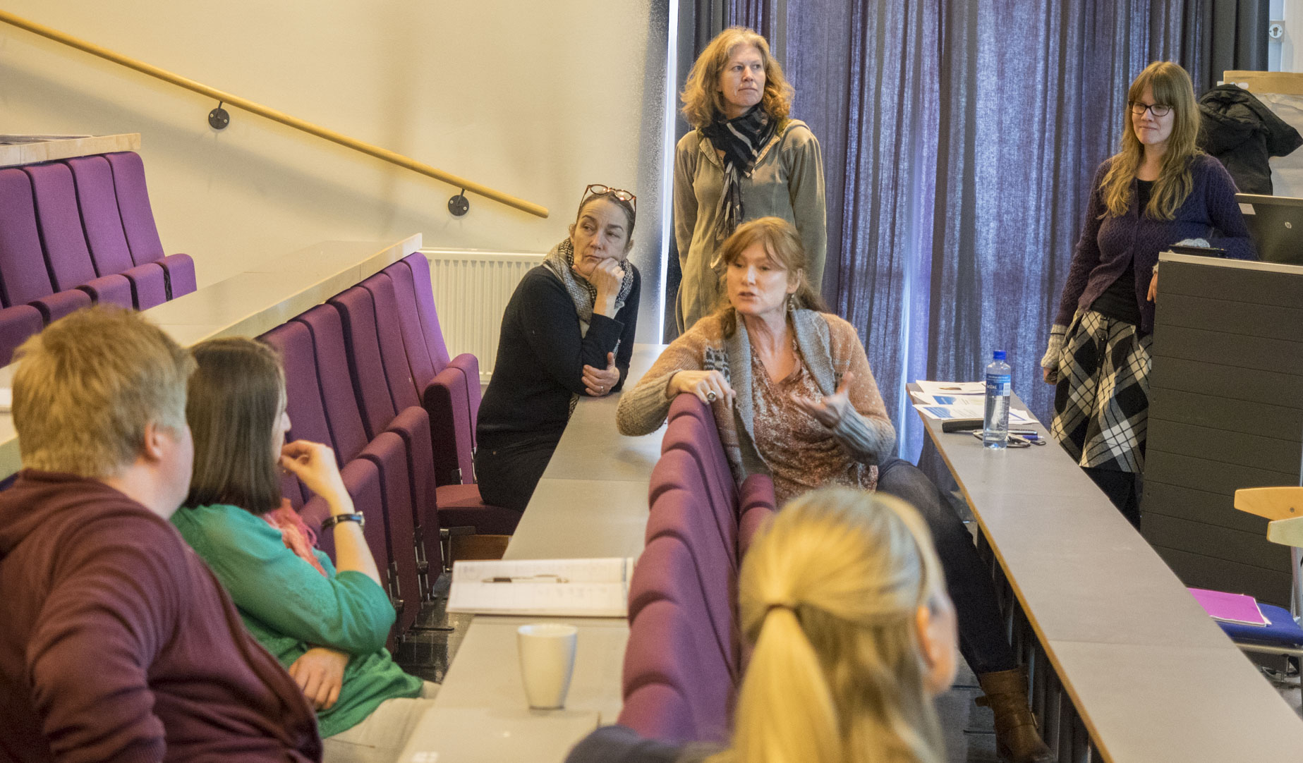 Noen lærere i et audtitorium diskuterer med prosjektgruppa.