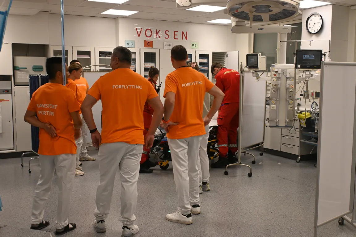 En gruppe mennesker i oransje skjorter